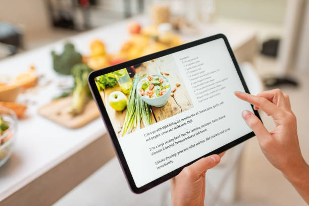 istock Cooking food using recipe on a digital tablet 1215072587