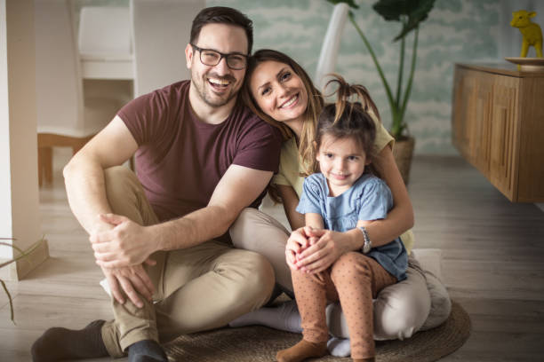 This is our time. This is our time. Parents with daughter at home. young family photos stock pictures, royalty-free photos & images
