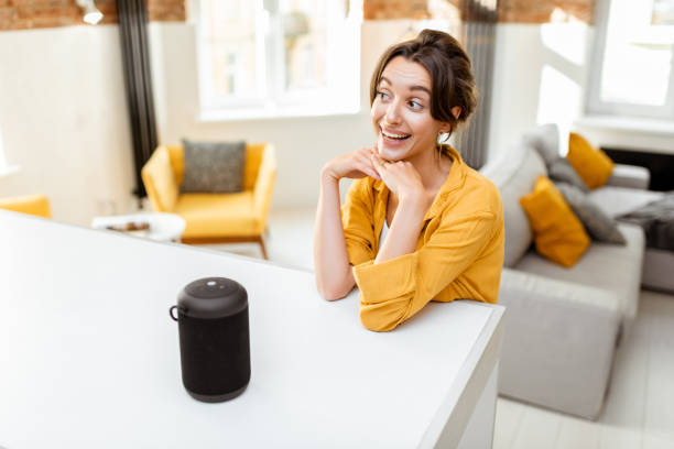 istock Woman controlling smart home devices with a voice commands 1215074589