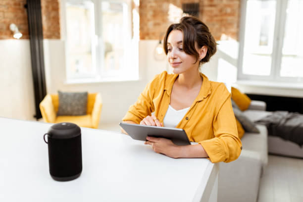 istock Woman controlling smart home devices with a voice commands 1215074620
