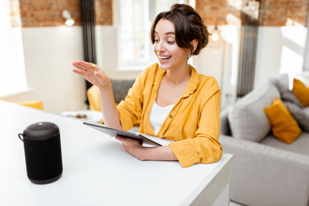 istock Woman controlling smart home devices with a voice commands 1215074642