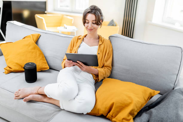 istock Woman with digital tablet relaxing at home 1215074707