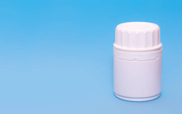 istock White medical bottle vial on a blue background.Copy space for text 1215075164