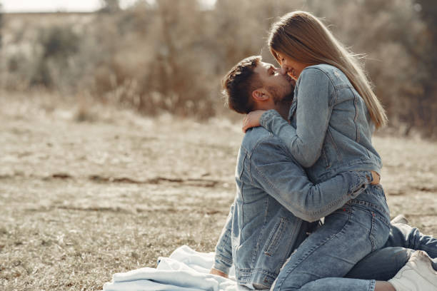 istock Cute couple in a jeans clothes in a spring field 1215080344