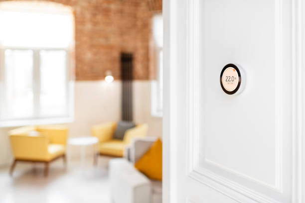 istock Thermostat with touch screen installed on the wall indoors 1215080438