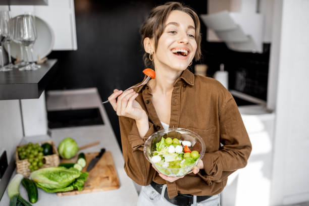 istock Woman with healthy salad on the kitchen 1215081352