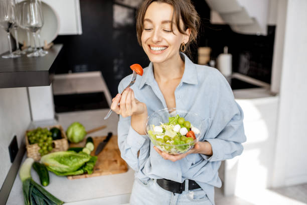 istock Woman with healthy salad on the kitchen 1215081389
