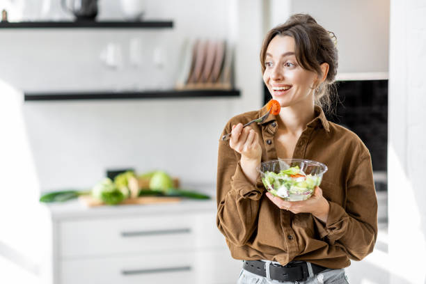istock Woman with healthy salad on the kitchen 1215082016