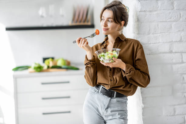 istock Woman with healthy salad on the kitchen 1215082022
