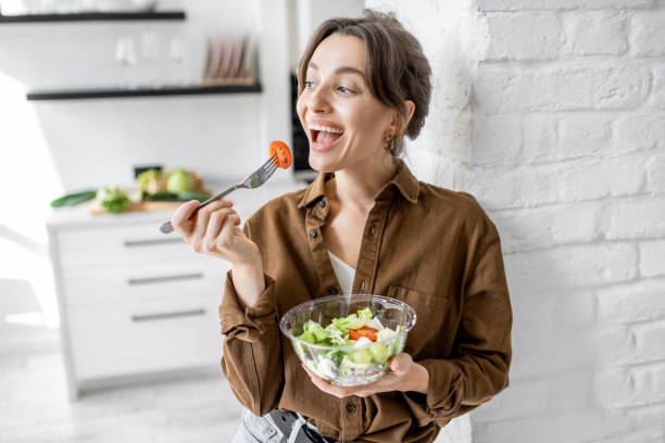 istock Woman with healthy salad on the kitchen 1215082025