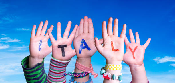 istock Children Hands Building Word Italy, Blue Sky 1215082499