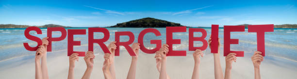 istock People Hands Holding Word Restricted Area Means Prohibited Area, Ocean Background 1215082706