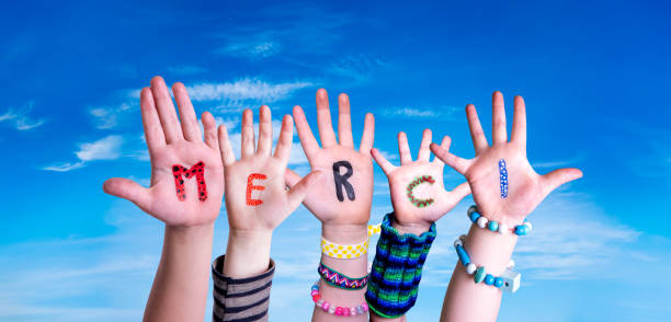 Children Hands Building Word Merci Means Thank You, Blue Sky Children Hands Building Colorful French Word Merci Means Thank You. Blue Sky As Background french language photos stock pictures, royalty-free photos & images