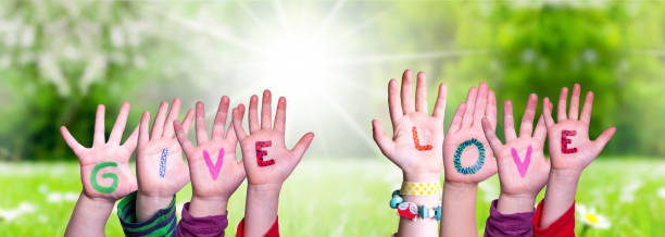 istock Children Hands Building Word Give Love, Grass Meadow 1215084070