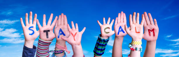 istock Children Hands Building Word Stay Calm, Blue Sky 1215084324