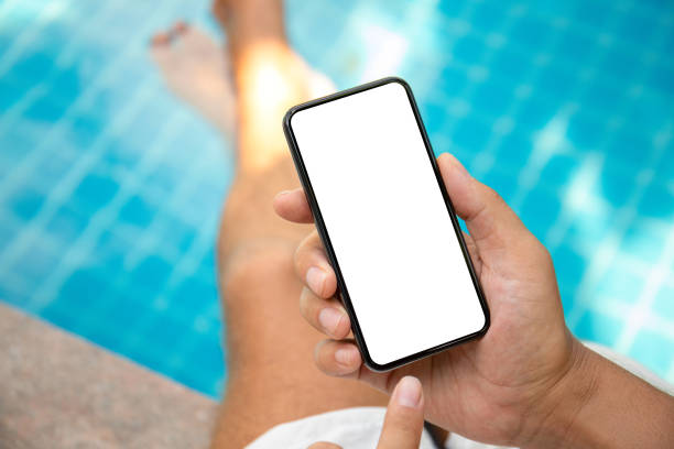 istock male hands holding phone with isolated screen in the pool 1215084351