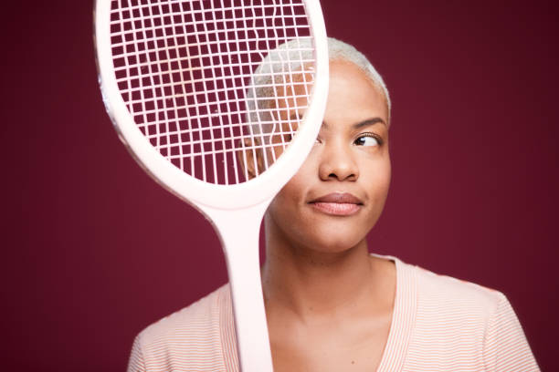 istock Young woman looking at broken tennis racket strings. 1215088500