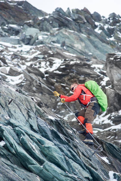 istock Male alpinist climbing rocky mountain. 1215088633