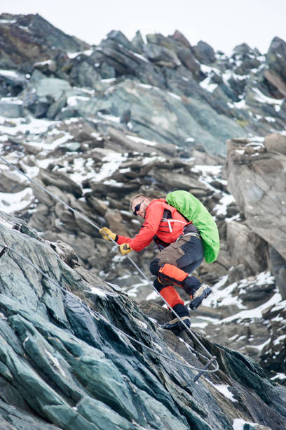 istock Male alpinist climbing rocky mountain. 1215088637
