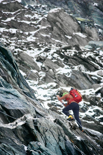 istock Male mountaineer climbing rocky mountain. 1215088668