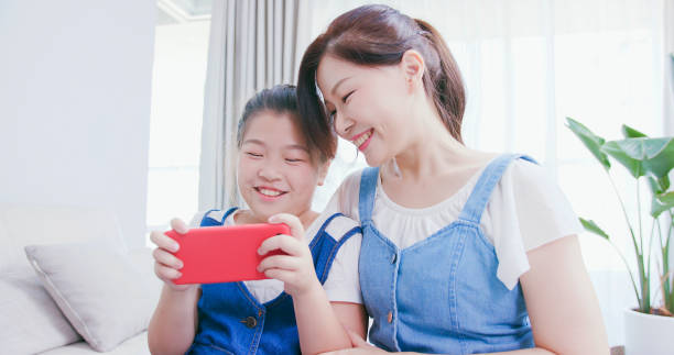 istock Daughter and mom use smartphone 1215088698