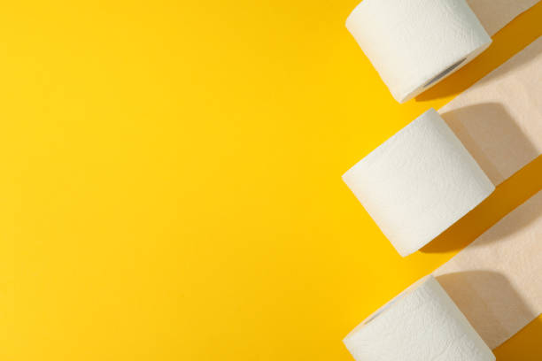 istock Toilet paper on yellow background, space for text 1215089520