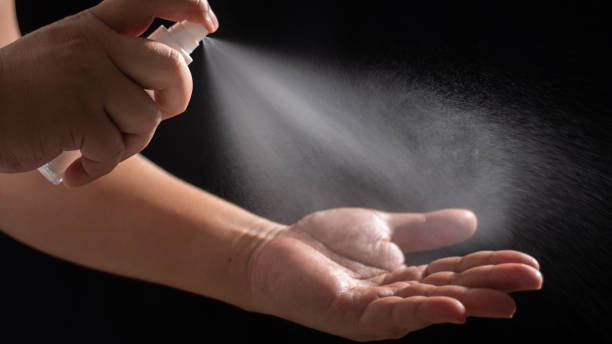 Hands sanitiser and washing with alcohol spray stock photo