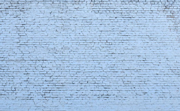 old light blue brick wall with a thick layer of paint