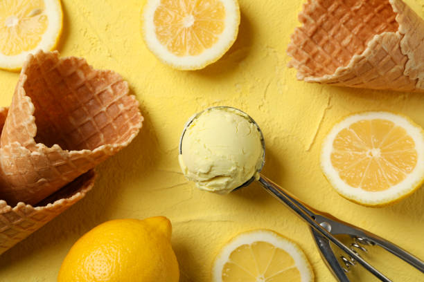 istock Ice cream, spoon, lemon and waffles on yellow background, top view 1215092894