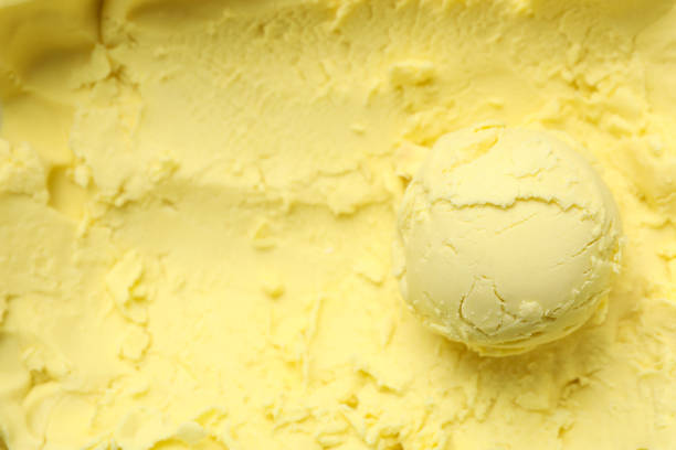 istock Ice cream ball on yellow background, close up 1215094017