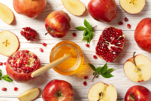 istock Apples, pomegranate and honey on wooden background, top view 1215094985