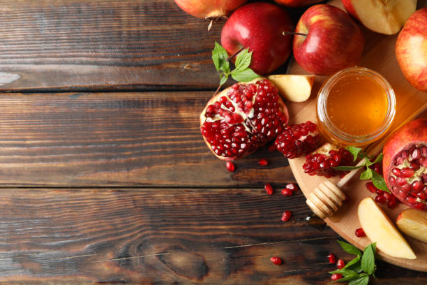 istock Apples, pomegranate and honey on wooden background, top view 1215095018