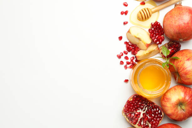 istock Apple, pomegranate and honey on white background, top view. Home treatment 1215095048