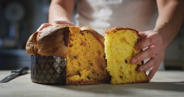 chef who controls the quality of his italian panettone by touching it with his hand to understand the softness. - fruitcake cake fruit dessert imagens e fotografias de stock