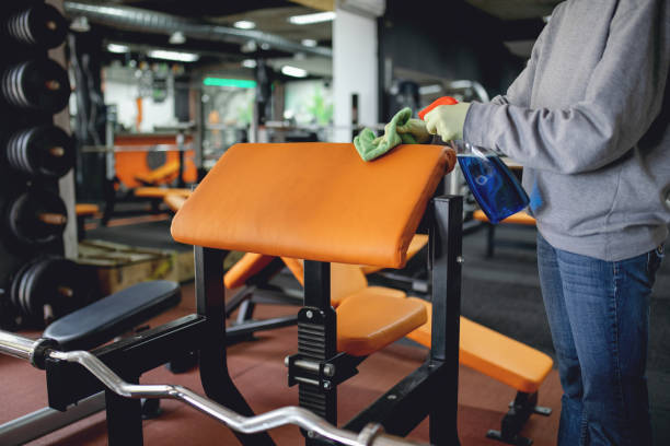 istock Woman disinfecting and cleaning gym 1215095111