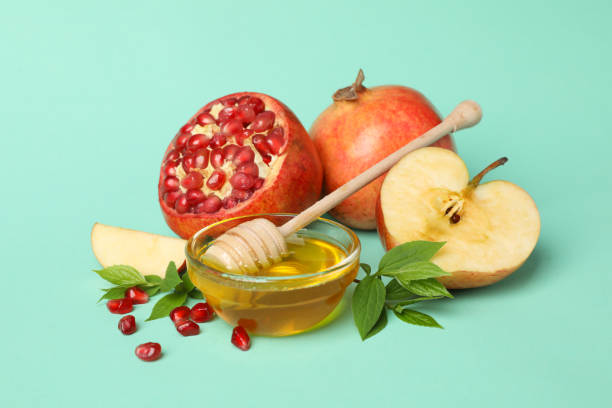 istock Apple, honey and pomegranate on mint background. Home treatment 1215095556