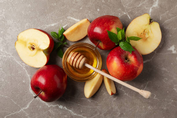 istock Apples and honey on gray background, top view 1215096321