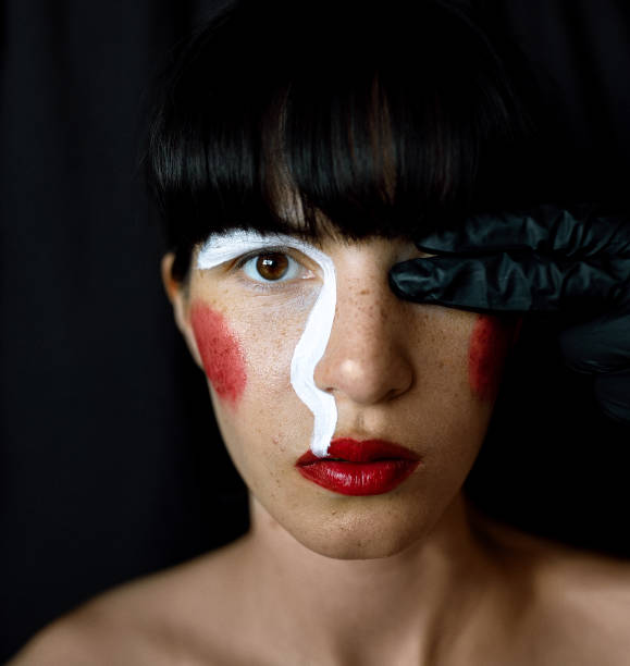 istock Beautiful woman with art painted makeup 1215096389