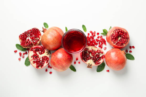 istock Pomegranate, juice and seeds on white background, top view 1215096697