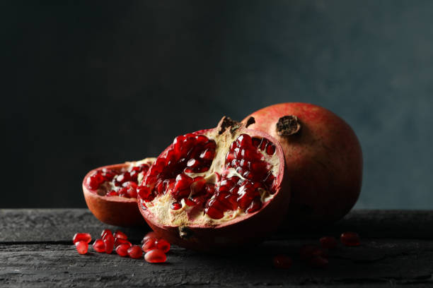 istock Pomegranate on wooden table, close up. Juicy fruit 1215096735