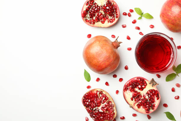 istock Flat lay with pomegranate, leaves and seeds on white background 1215096855