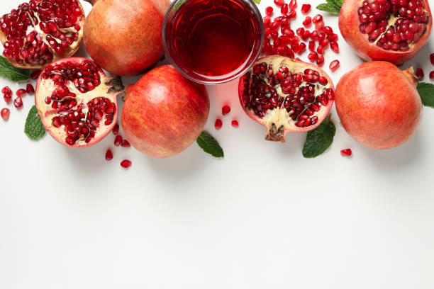 istock Pomegranate, juice and seeds on white background, top view 1215096931