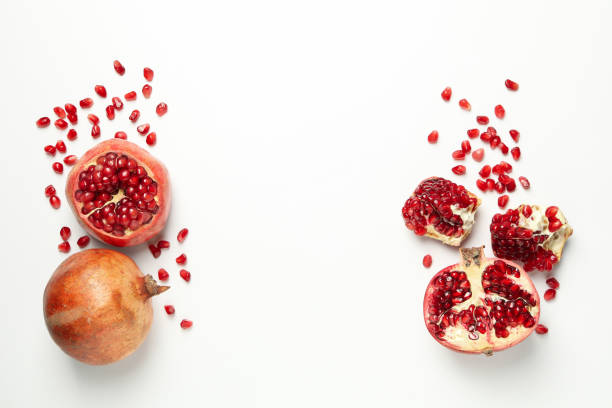 istock Pomegranate and seeds on white background, space for text 1215097912