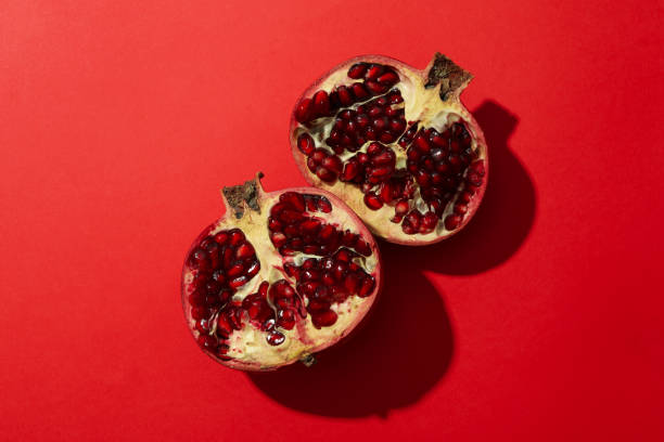 istock Pomegranate on red background, top view. Juicy fruit 1215098130