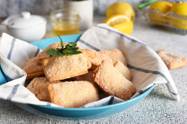 istock Lemon cookies with sugar and zest on the kitchen table. 1215100204