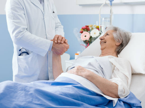 istock Doctor visiting an elderly patient and comforting her 1215105262