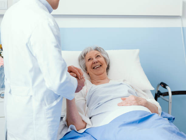 istock Doctor visiting an elderly patient and comforting her 1215107049