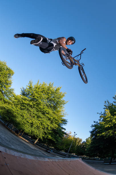 istock Biker jump high from jump box ramp performing dangerous superman trick. 1215108290