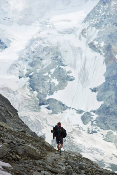 istock Tourist with backpack walking in mountains. 1215108493