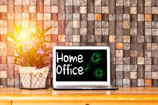 Home office theme. Home office during coronavirus pandemic. Novel coronavirus 2019 COVID-19 theme. Coronavirus wallpaper on computer.